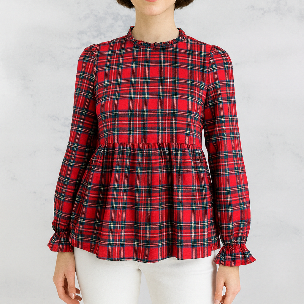 Woman wearing a red plaid blouse against a white background